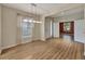 Open-concept living room featuring hardwood floors, large windows, and ample natural light at 10444 48Th E Ct, Parrish, FL 34219