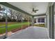 Screened patio overlooking the backyard with a ceiling fan at 10444 48Th E Ct, Parrish, FL 34219