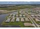 Wide shot of a large community featuring numerous homes and a central lake at 15967 Clear Skies Pl, Lakewood Ranch, FL 34211