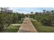 Landscaped walkway leading to tennis courts and more at 15967 Clear Skies Pl, Lakewood Ranch, FL 34211