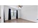 Spacious bedroom with neutral walls and dark blue curtains at 15967 Clear Skies Pl, Lakewood Ranch, FL 34211