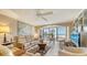 Relaxing living room with ocean views, comfortable seating, and large windows at 19 Whispering Sands Dr # 201, Sarasota, FL 34242