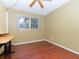 Bedroom features wood-look floors, a ceiling fan, and a window at 2465 Northside Dr # 906, Clearwater, FL 33761