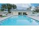 Relaxing community pool area with poolside seating and a nearby building at 2465 Northside Dr # 906, Clearwater, FL 33761