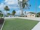 Community putting green with artificial turf, white vinyl fence, and palm trees at 2465 Northside Dr # 906, Clearwater, FL 33761