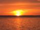 Breathtaking sunset over calm water, creating a fiery sky at 3710 Gulf Of Mexico Dr # F1, Longboat Key, FL 34228