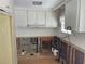 Kitchen needing renovation with white cabinetry, plumbing and electrical exposed, showing the potential layout at 3710 Gulf Of Mexico Dr # F1, Longboat Key, FL 34228