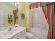 Bathroom with a shower/tub combo and striped curtains at 7011 Woodmore Ter, Lakewood Ranch, FL 34202