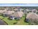 An aerial view of homes shows the community's layout with lakes and mature landscaping at 7011 Woodmore Ter, Lakewood Ranch, FL 34202