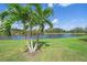 A picturesque backyard features a pristine lake and lush landscaping at 7011 Woodmore Ter, Lakewood Ranch, FL 34202
