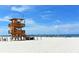 Beautiful white sandy beach featuring a lifeguard tower and clear blue waters, perfect for a relaxing day at 7011 Woodmore Ter, Lakewood Ranch, FL 34202