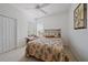 Comfortable bedroom featuring a large window, ceiling fan and carpeted floors at 7011 Woodmore Ter, Lakewood Ranch, FL 34202