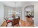Bright dining room with natural light, round table, and a view to the living room at 7011 Woodmore Ter, Lakewood Ranch, FL 34202