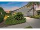 Beautiful home featuring a well-manicured lawn, tropical foliage, and a two-car garage at 7011 Woodmore Ter, Lakewood Ranch, FL 34202