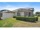 A well-maintained home features a screened lanai and manicured landscaping at 7011 Woodmore Ter, Lakewood Ranch, FL 34202