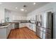 Bright kitchen with white cabinets, stainless steel appliances and granite countertops at 7011 Woodmore Ter, Lakewood Ranch, FL 34202
