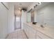 Bright bathroom with double vanity, large mirrors and a walk-in shower at 7011 Woodmore Ter, Lakewood Ranch, FL 34202