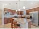 Spacious kitchen featuring granite countertops and wood cabinetry at 7767 Summerland Cv, Lakewood Ranch, FL 34202