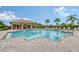 Community pool with patio and lounge chairs at 7767 Summerland Cv, Lakewood Ranch, FL 34202