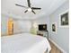 King-size bed in this spacious bedroom with a TV and dresser at 7820 34Th W Ave # 102, Bradenton, FL 34209