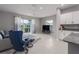 Living room with sectional sofa, sliding glass doors, and kitchen cabinets visible at 11655 Bluestone Ct, Parrish, FL 34219