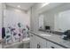 Clean bathroom with granite countertop, shower, and floral shower curtain at 11655 Bluestone Ct, Parrish, FL 34219