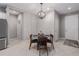 Bright dining area with a glass-top table and four mid-century modern chairs at 11655 Bluestone Ct, Parrish, FL 34219