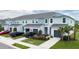 Two-story townhouses with attached garages and landscaping at 11655 Bluestone Ct, Parrish, FL 34219