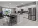 Modern kitchen with white cabinets, granite countertops, and stainless steel appliances at 11655 Bluestone Ct, Parrish, FL 34219