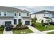Two-story townhome with gray and blue exterior, two-car garage, and landscaped lawn at 11655 Bluestone Ct, Parrish, FL 34219