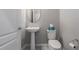 Clean and modern half bathroom with pedestal sink and toilet at 11655 Bluestone Ct, Parrish, FL 34219