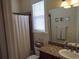 Bathroom with shower, toilet, and granite vanity with linen towels at 11776 Angler'S Club Dr, Placida, FL 33946