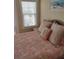 Bedroom with coastal bedding and a window with blinds at 11776 Angler'S Club Dr, Placida, FL 33946