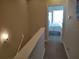 Upstairs hallway with access to bedrooms and a view of a bedroom at 11776 Angler'S Club Dr, Placida, FL 33946