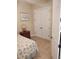 Bedroom with double doors leading to a large closet, a nightstand, and a bed with coastal bedding at 11776 Angler'S Club Dr, Placida, FL 33946