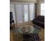 Living room showcasing a comfortable seating area and a glass-top coffee table at 11776 Angler'S Club Dr, Placida, FL 33946