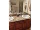 Double vanity bathroom with granite countertop and shower at 11776 Angler'S Club Dr, Placida, FL 33946