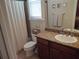 Clean bathroom with shower, toilet, and granite vanity at 11776 Angler'S Club Dr, Placida, FL 33946