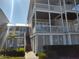 Two-story home with wrap-around porch and landscaped yard at 11776 Angler'S Club Dr, Placida, FL 33946