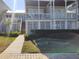 Two-story home with wrap-around porch and landscaped yard at 11776 Angler'S Club Dr, Placida, FL 33946