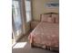 Bedroom with coastal bedding and private balcony access at 11776 Angler'S Club Dr, Placida, FL 33946