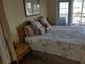 King-size bed, nightstand, and access to balcony at 11776 Angler'S Club Dr, Placida, FL 33946