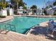 Community pool with lounge chairs and tables at 11776 Angler'S Club Dr, Placida, FL 33946