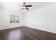 Bedroom with dark brown wood flooring and a window at 12928 24Th E Ct, Parrish, FL 34219