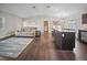 Open concept living room and kitchen with dark floors at 15 Tulane Rd, Venice, FL 34293