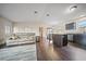 Open concept living room and kitchen with dark floors at 15 Tulane Rd, Venice, FL 34293