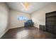 Bedroom with wood flooring, a ceiling fan, and built-in shelving at 15 Tulane Rd, Venice, FL 34293