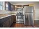 Stainless steel appliances and dark wood cabinets in this kitchen at 15 Tulane Rd, Venice, FL 34293