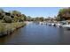 Calm waterway lined with docked boats and lush foliage at 1716 Glenhouse Dr # 320, Sarasota, FL 34231