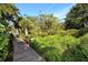 Wooden boardwalk path through lush landscaping, leading to water view at 1716 Glenhouse Dr # 320, Sarasota, FL 34231